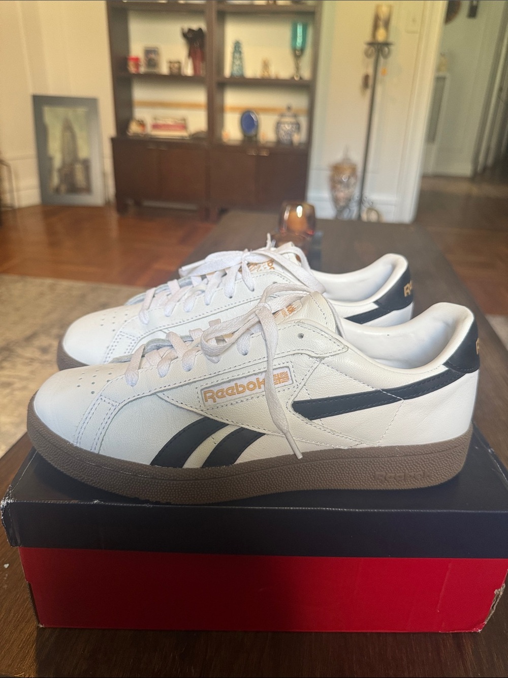 Reebok White Leather Low-Top Sneakers with Black Stripes and Brown Sole